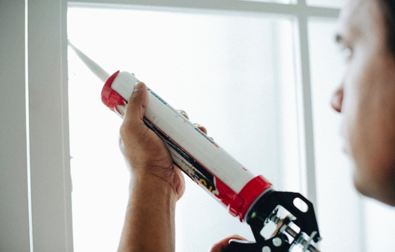Person Caulking Window