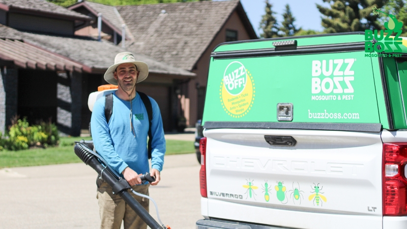 Buzz Boss worker preparing to spray a yard against pests